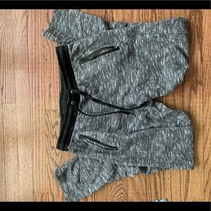Grey sweats with leather like material round waist